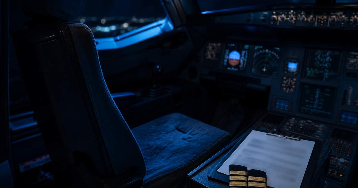 Empty airline captain's seat in a dim cockpit with epaulettes and an unreadable document on the console, representing pilot credential fraud
